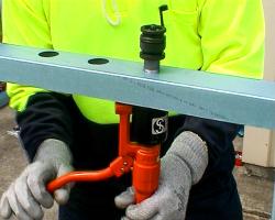 Making holes using a manual hydraulic punch